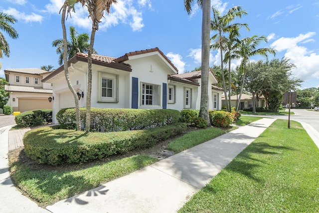 mediterranean / spanish-style house with a front yard