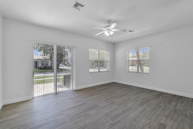 unfurnished room with ceiling fan and dark hardwood / wood-style flooring