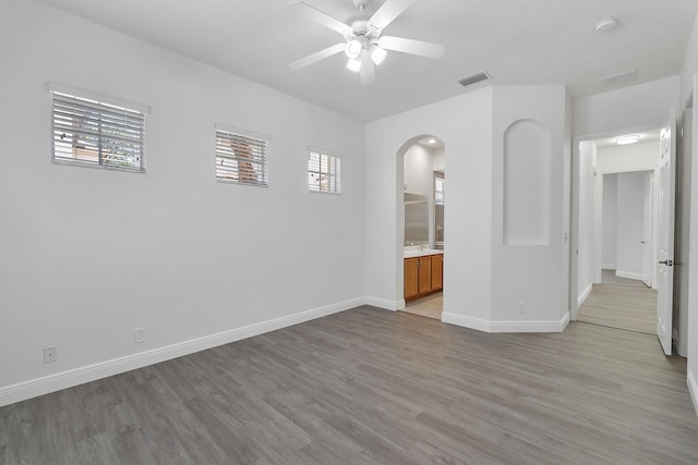 unfurnished room with ceiling fan, a healthy amount of sunlight, and light hardwood / wood-style flooring