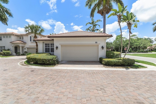 mediterranean / spanish-style house with a garage