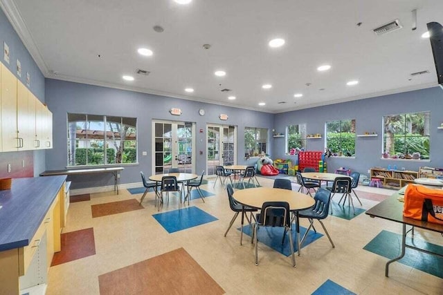 rec room featuring ornamental molding and french doors