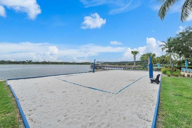 view of property's community with a water view and volleyball court