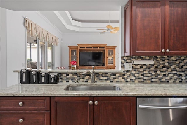 kitchen featuring ceiling fan, tasteful backsplash, light stone countertops, stainless steel dishwasher, and sink