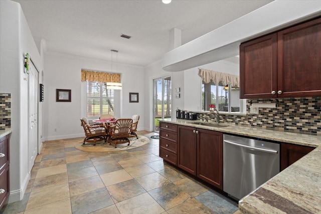 kitchen with stainless steel dishwasher, decorative light fixtures, sink, and decorative backsplash