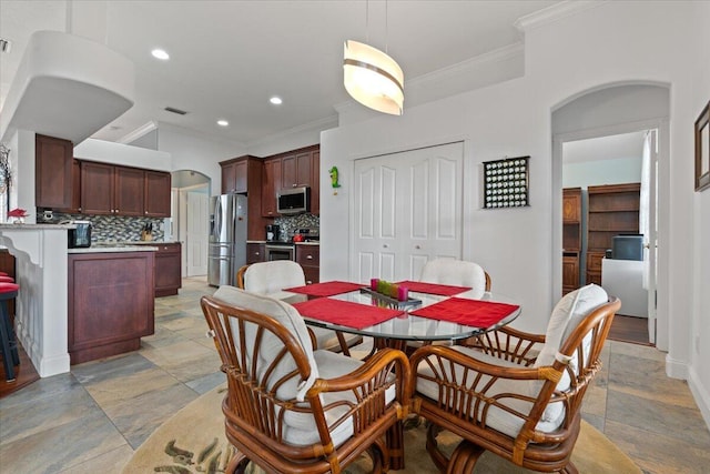 dining space with crown molding