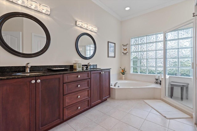 bathroom featuring vanity, ornamental molding, tile patterned floors, and a tub