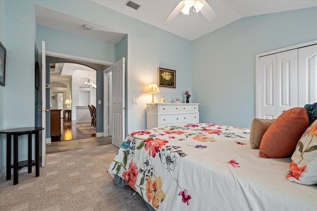 carpeted bedroom featuring ceiling fan, a closet, and vaulted ceiling