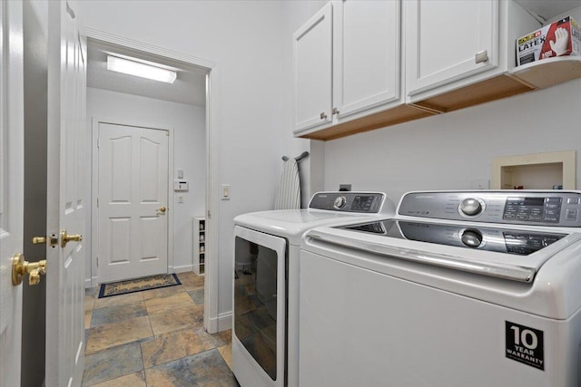 laundry room featuring cabinets and separate washer and dryer