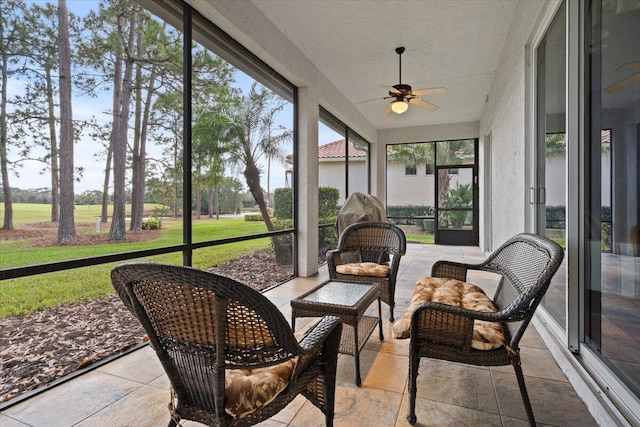 sunroom featuring ceiling fan and a healthy amount of sunlight