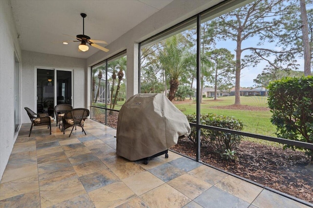 sunroom featuring ceiling fan