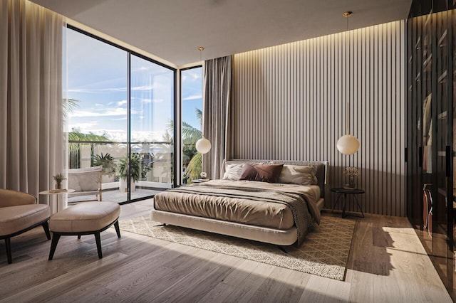 bedroom with a wall of windows and hardwood / wood-style floors