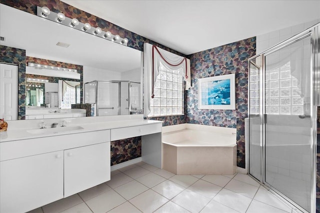 bathroom featuring vanity, tile patterned floors, and shower with separate bathtub