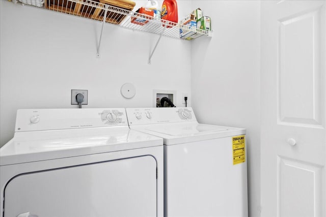 clothes washing area with washer and clothes dryer