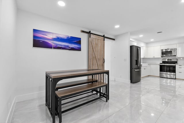 2112 N 14th Ter, Hollywood, FL 33020 - living area with a barn door, recessed lighting, and light marble finish floors