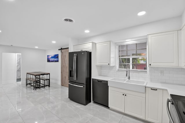2112 N 14th Ter, Hollywood, FL 33020 - kitchen featuring black appliances, a barn door, tasteful backsplash, light countertops, and recessed lighting