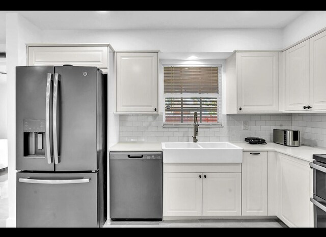 kitchen with dishwasher, white cabinetry, decorative backsplash, sink, and stainless steel fridge with ice dispenser