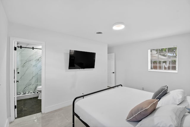 2112 N 14th Ter, Hollywood, FL 33020 - bedroom with ensuite bath and baseboards
