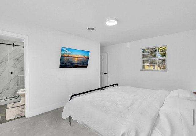 bedroom featuring ensuite bathroom and baseboard heating