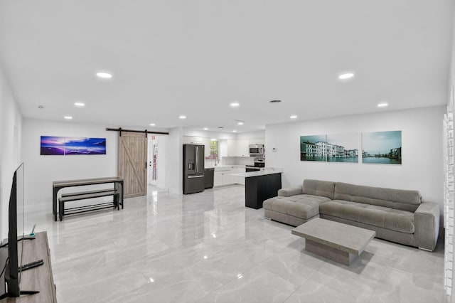 2112 N 14th Ter, Hollywood, FL 33020 - living area featuring a barn door, light marble finish flooring, and recessed lighting