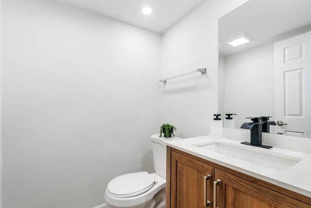 bathroom with toilet and vanity