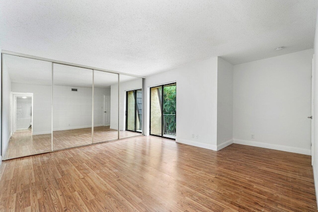 unfurnished bedroom featuring a textured ceiling and hardwood / wood-style floors