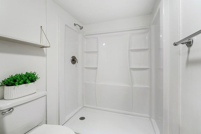 bathroom with walk in shower and toilet