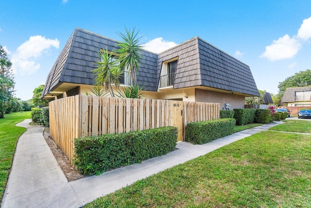 view of property exterior with a yard