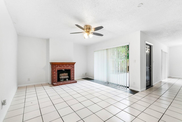 unfurnished living room featuring a textured ceiling, ceiling fan, light tile patterned floors, and a brick fireplace