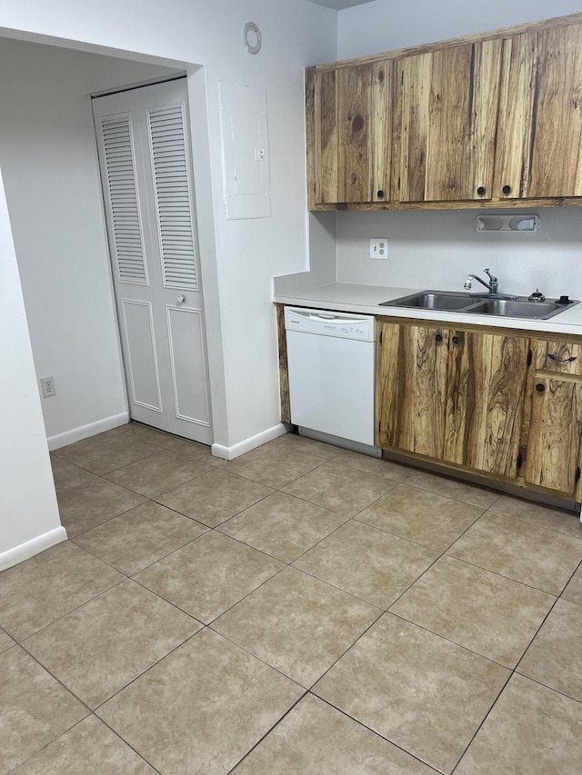 kitchen featuring light tile patterned floors, sink, white dishwasher, and electric panel