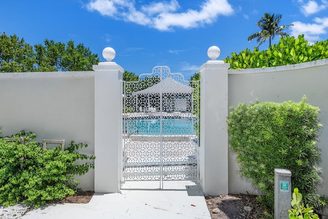 view of gate with a community pool