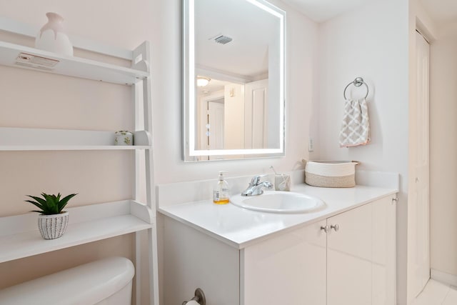 bathroom with toilet and vanity