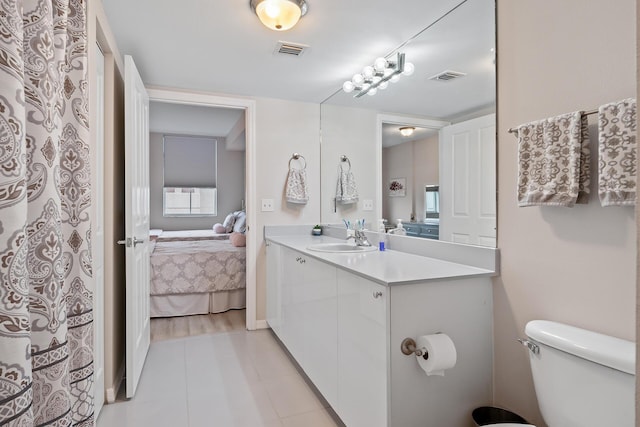 bathroom with toilet and vanity