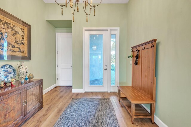 entryway with a notable chandelier and light hardwood / wood-style floors