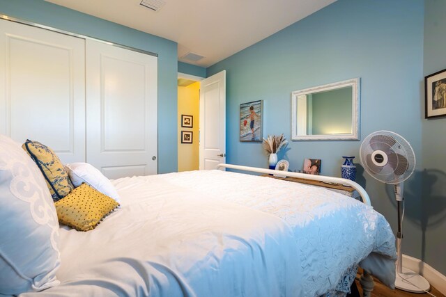 bedroom with a closet and hardwood / wood-style floors