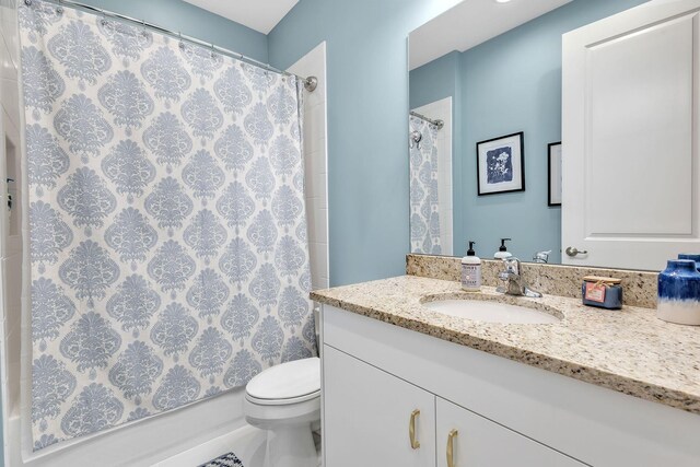 bathroom with toilet and vanity