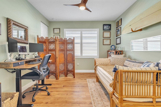 home office with ceiling fan and light wood-type flooring