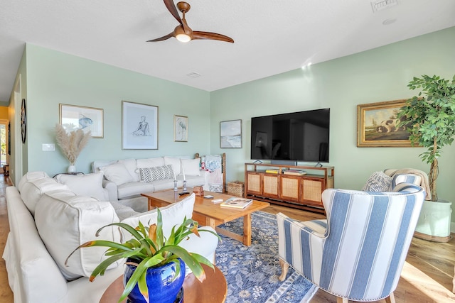 living room with ceiling fan and light wood-type flooring