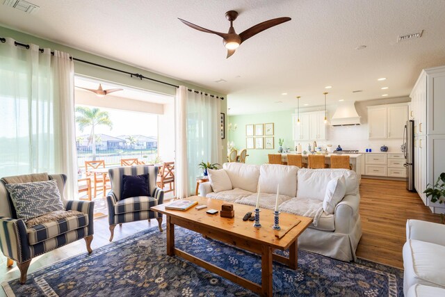 dining room with wood-type flooring and ceiling fan with notable chandelier