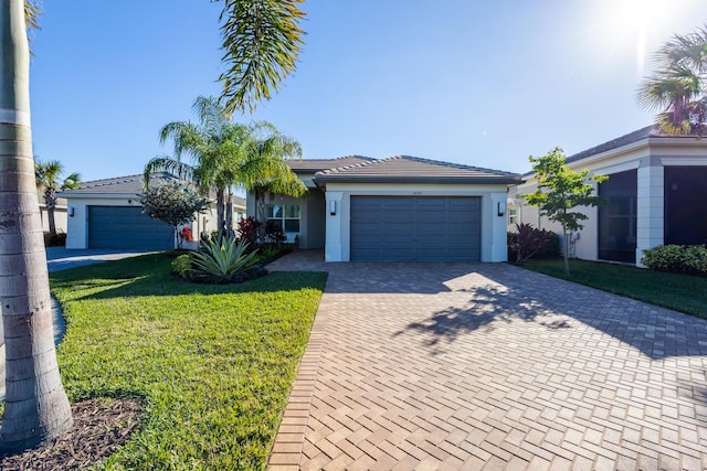 single story home with a garage and a front yard