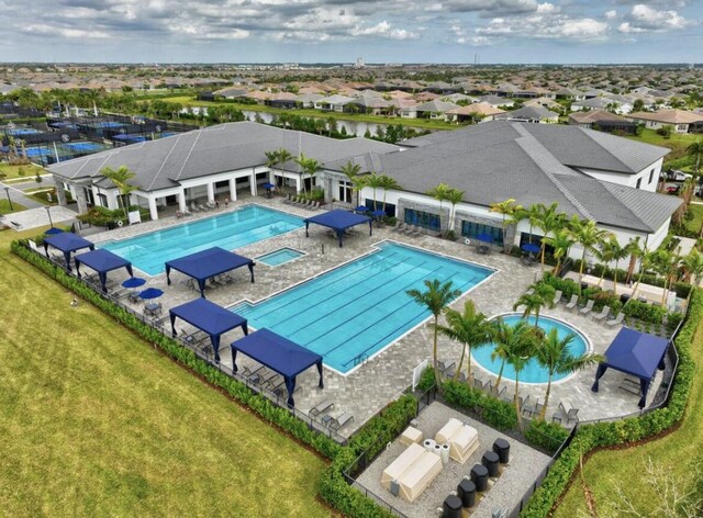 view of pool featuring a lawn and a patio