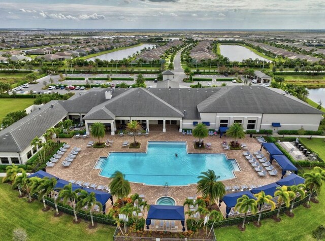 view of swimming pool with a water view and a patio