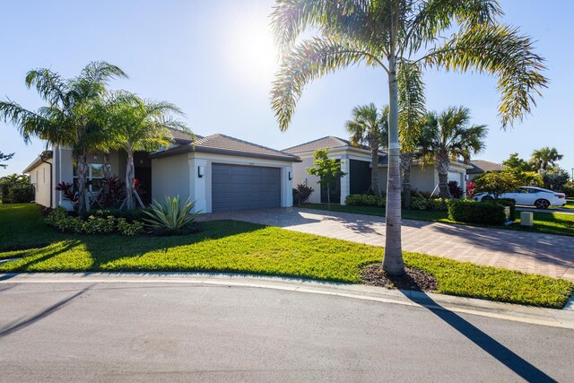 view of front of property with a front yard and a garage