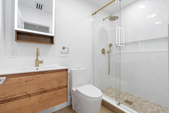 bathroom with toilet, walk in shower, and vanity