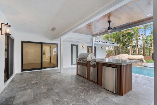 view of patio / terrace with ceiling fan, exterior kitchen, and grilling area