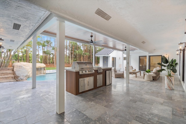 view of patio featuring ceiling fan, an outdoor living space, exterior kitchen, and a grill