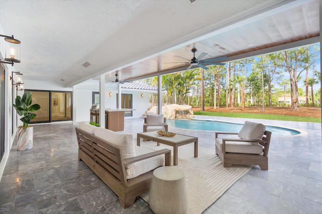 view of swimming pool with ceiling fan, outdoor lounge area, and a patio