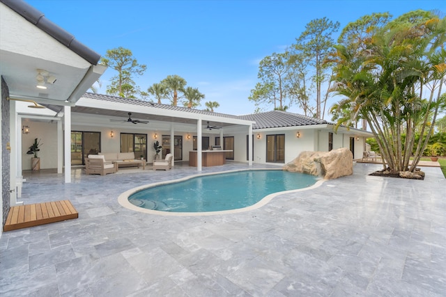 view of swimming pool with ceiling fan, an outdoor living space, and a patio