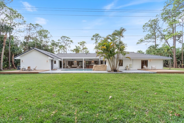 back of house featuring a patio area and a yard