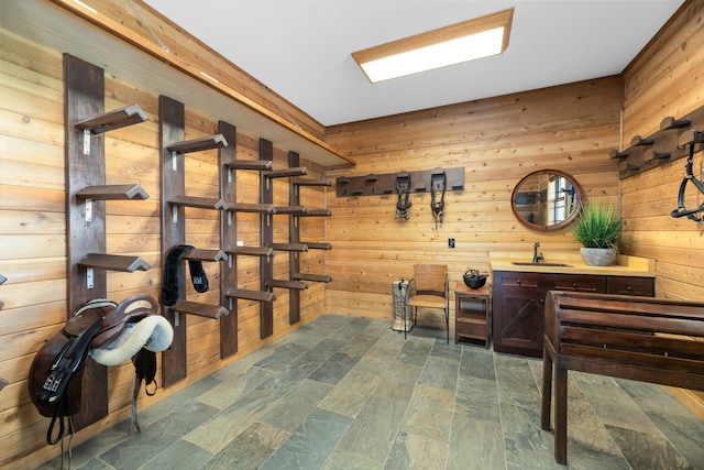 interior space featuring sink and wood walls