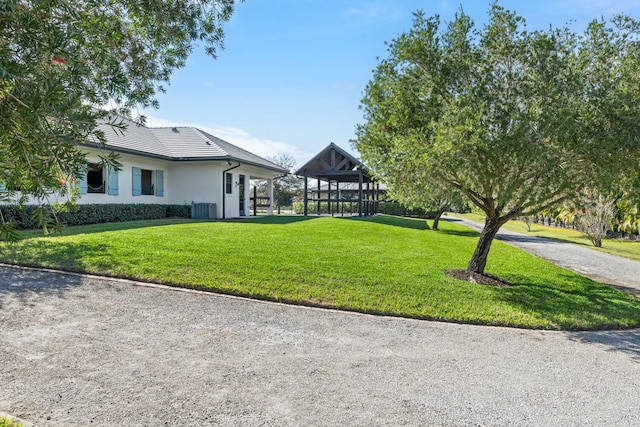 view of yard with a gazebo and central air condition unit